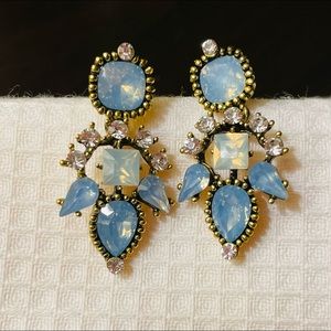 Light blue dangling earrings with stones. Gold accent